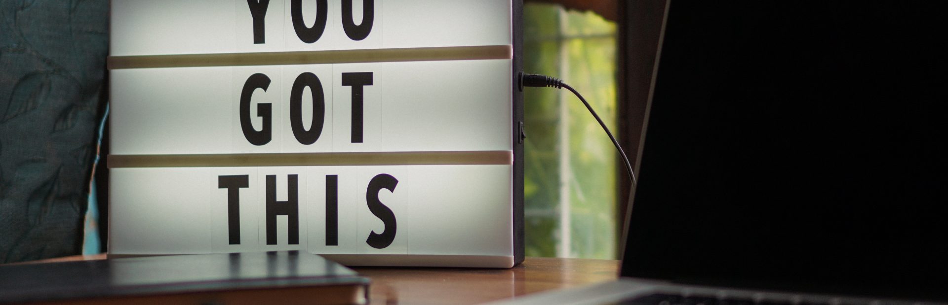 Sign saying "You Got This" next to a computer
