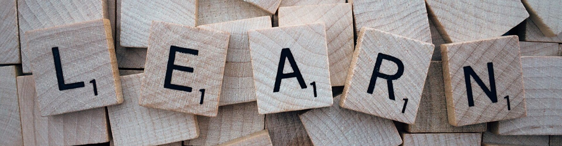 Scrabble letters spelling the word "Learn"