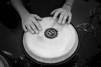 Hands with rhythm beating on a drum