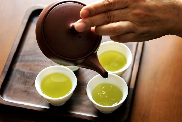 Pouring green tea with caffeine