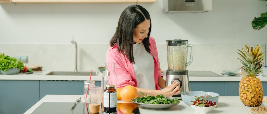 Healthy woman making a smoothie