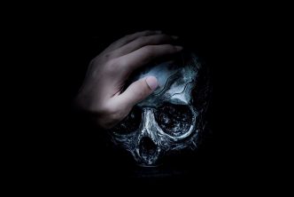 Friend of death, placing hand on skull