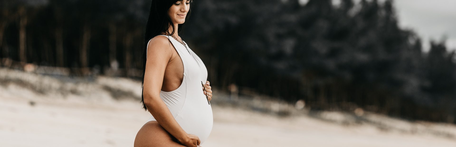 Pregnant woman getting ready to swim