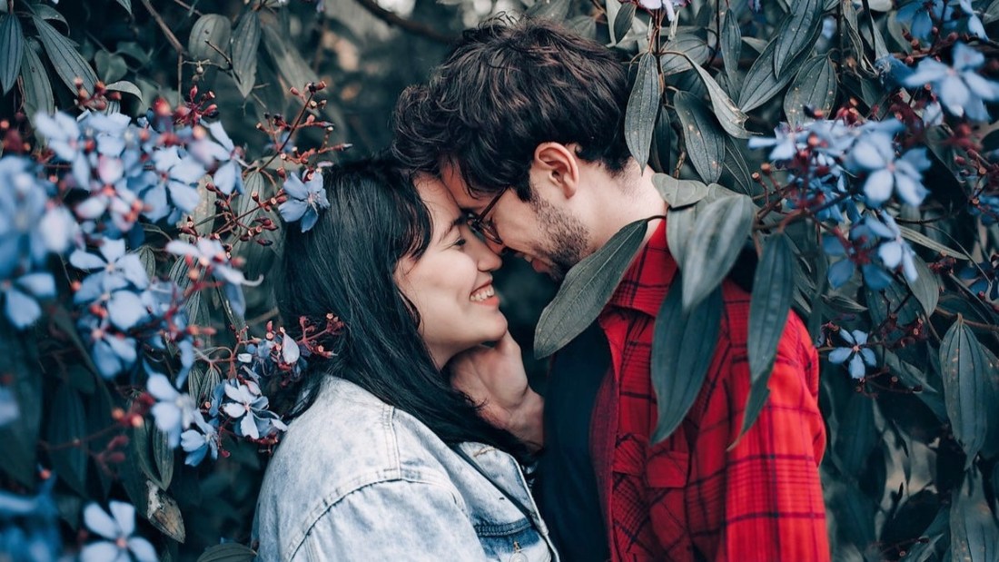 Loving couple standing under a tree