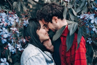 Loving couple standing under a tree