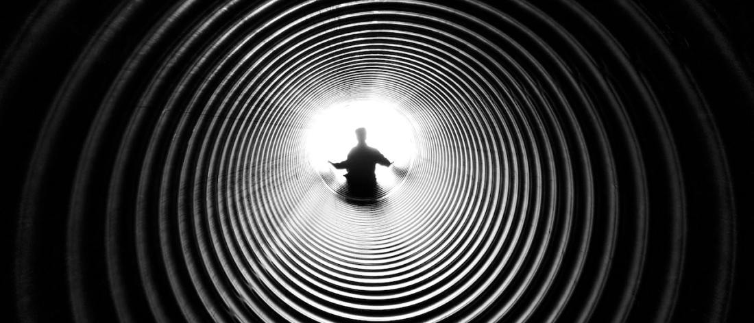 Man in light at end of a tunnel afterlife
