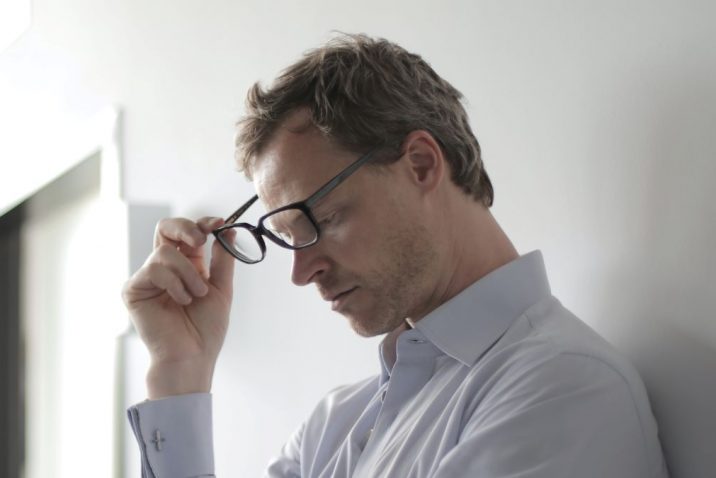 Man removing glasses