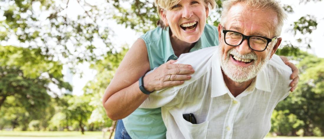 Optimistic couple in park enjoying longevity
