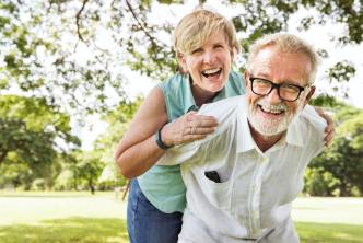 Optimistic couple in park enjoying longevity