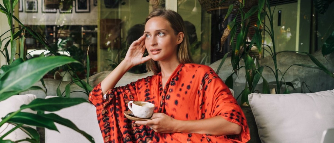 Woman daydreaming in a cafe